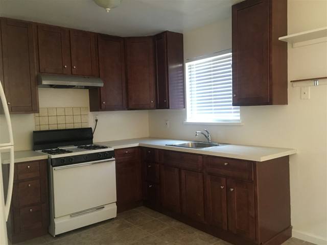 Kitchen with gas range and dark wood cabinets