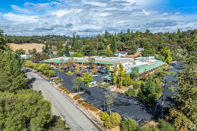 Aerial view along Combie Road with the Lake of the Pines pines behind the center