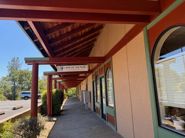 Covered storefront arcade with timber beams and arched windows