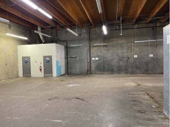 Unit 112 — rear of the space with roll-up doors